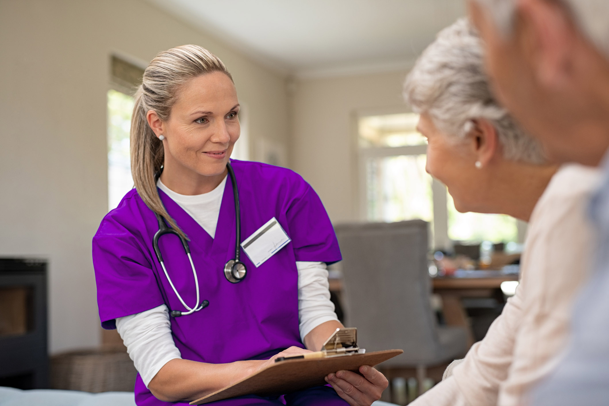 Friendly nurse talking with old couple ONE Health Ohio Clinicians and Nurses helping the community | Health and Wellness | Private Clinic
